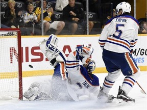 The puck gets past Edmonton Oilers defenceman Mark Fayne and goalie Cam Talbot during Saturday's 2-0
NHL loss to the Predators on Saturday, Oct. 10, 2015, in Nashville, Tenn.