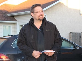 David Yurdiga, Fort McMurray-Cold Lake's Conservative candidate, listens to a supporter while canvassing in Fort McMurray in October  2015.