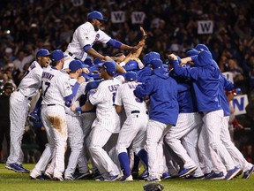 The Chicago Cubs celebrate defeating the St. Louis Cardinals 6-4 in Game 4 of the National League Division Series at Wrigley Field on October 13, 2015 in Chicago.