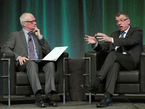 University of Alberta School of Business dean Joseph Doucet, left, and U of A president David Turpin speak at a luncheon with local business leaders at the Shaw Conference Centre on Oct. 15, 2015.