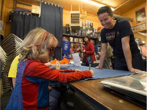 Mable Tooke, 6, better known as Spider-Mable, autographs Spider Mable posters at Happy Harbor Comics on Oct. 2, 2015 in Edmonton.