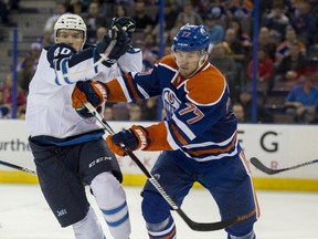 Oscar Klefbom  of the Edmonton Oilers gets past Joel Armia of the Winnipeg Jets at Rexall Place during pre-season NHL action.