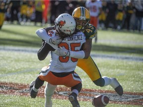 Edmonton Eskimos linebacker Dexter McCoil wraps up Shaquille Murray-Lawrence of the B.C. Lions in a CFL game at Commonwealth Stadium on Sept. 26, 2015.