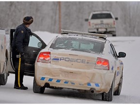 Police investigate a rural residence east of Edmonton  near Tofield. An Alberta man who shot one RCMP officer and ran over another who jumped onto his truck during an hours-long shootout has been sentenced to a dozen years in prison.