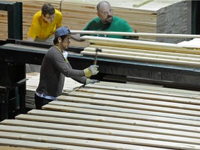 Workers cut and bundle lumber at Spruceland Millworks in Acheson, west of Edmonton, in this July 8, 2014 file photo.
