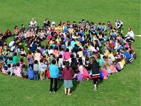 Students from Meadowlark Elementary School gather in the field outside their school to participate in outdoor fitness activities.