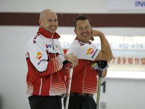 Kevin Koe, left, and lead Ben Hebert share a laugh during the Direct Horizontal Drilling Fall Classic men's bonspiel final against Brendan Bottcher of the Saville Centre on Monday, Oct. 12, 2015, at the Crestwood Curling Club.