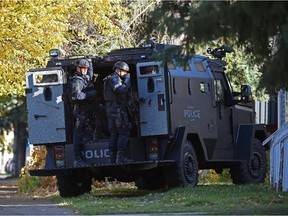 A police armoured car outside a residence on 77th Avenue near 104th Street in Edmonton on Monday, Oct. 13, 2015.
