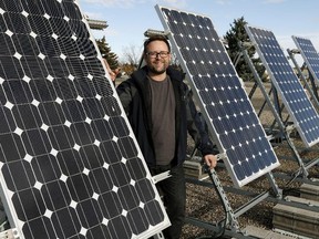Teacher Aaron Dublenko shows off the solar panels on the roof of Queen Elizabeth High School in Edmonton in 2015.