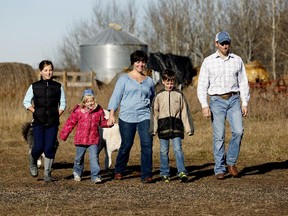 Farmers Shannon and Dan Ruzicka and their three children are conducting an experiment for a year during which they try to live off local products that they either grow or purchase from another local farmer. Also in photo are their children Molly, Joshua and Madalynne.