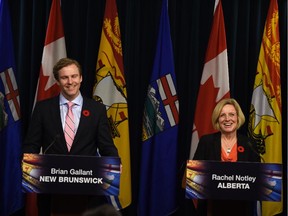 Alberta Premier Rachel Notley and her New Brunswick counterpart Brian Gallant address the media at the Legislature in Edmonton on Thursday, Oct. 29, 2015.
