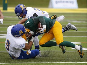 U of A Golden Bears' Jimmy Ralph is tackled during Canada West Universities Athletic Association football game action at Foote Field in Edmonton on Saturday Oct. 3, 2015. The Bears lost 39-21.