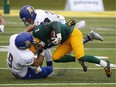 University of Alberta Golden Bears' Jimmy Ralph puts his head down against UBC Thunderbirds players at Foote Field in Edmonton on Oct. 3, 2015.