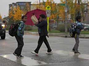 Pedestrians and traffic near Dr. Donald Massey Elementary-Junior High School in Edmonton.