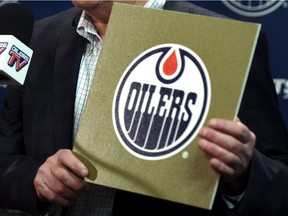 Oilers CEO Bob Nicholson holds the gold card from the 2015 NHL Draft Lottery Draw.