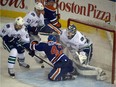 Anton Slepyshev (42) slides into goalie Jacob Markstrom (25) as the Oilers play the Vancouver Canucks in Edmonton, October 1, 2015.