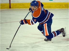 Taylor Hall (4) shoots as the Oilers play the Vancouver Canucks in Edmonton, October 1, 2015.