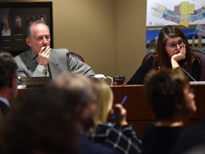 Trustees John Acheson and Laura Thibert listening to speakers at the Edmonton Catholic school board meeting as they discuss a controversial policy designed to support transgender students and staff, at the Catholic Education Services building in Edmonton, Oct. 13, 2015.