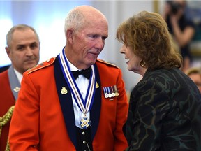 Edmontonian Dennis Erker receiving a medal from Lieutenant Governor Lois Mitchell (R) along with seven Albertans, including three Edmontonians, received the Alberta Order of Excellence for 2015 during a ceremony at Government House in Edmonton last week.