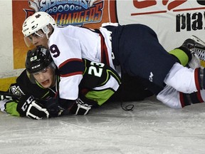 Colton Kehler of the Edmonton Oil Kings gets pinned to the ice by Regina Pats' Colton Kroeker during a Western Hockey League game at Rexall Place on Oct. 17, 2015.