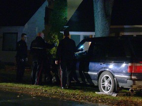 A bullet hole is seen in the windshield of a vehicle found near 96th Street and 78th Avenue after police fired at the fleeing vehicle late Monday.