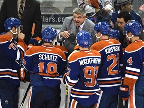 Edmonton Oilers head coach Todd McLellan instructs his players during a game against the Detroit Red Wings at Rexall Place in Edmonton on Oct. 21, 2015.