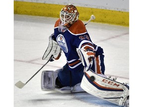 The puck flies past Edmonton Oilers goalie Cam Talbot (33) during NHL action against the Detroit Red Wings at Rexall Place in Edmonton on Oct. 21, 2015.