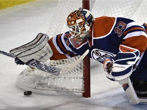 Edmonton Oilers goalie Cam Talbot (33) is about to pounce on the puck against the Detroit Red Wings during NHL action action at Rexall Place in Edmonton on Oct. 22, 2015.