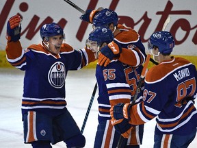Edmonton Oilers Mark Letestu (55) scores their first goal celebrating with teammates against Detroit Red Wings during NHL action action at Rexall Place in Edmonton, October 22, 2015.