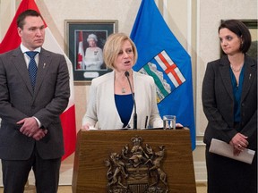 Premier Rachel Notley stands with Deron Bilous, Minister of Economic Development and Trade, left, and Danielle Larivee, Minister of Municipal Affairs and Minister of Service Alberta, during a news conference at Government House following a cabinet shuffle in Edmonton on Oct. 22, 2015.