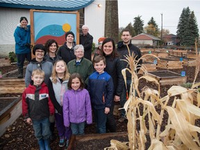 Sherry Prokopuk, at right in black, is the co-ordinator of the Fulton Place Community Garden. The city of Edmonton is making it easier for interested citizens to find appropriate land and start more urban agriculture projects like this one.
