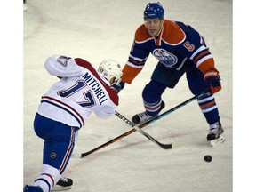 EDMONTON, ALTA: ¬†OCTOBER 29, 2015 -- Torrey Mitchell (17) scores with Mark Fayne (5) tiring to block as the Edmonton Oilers play the Montreal Canadiens at Rexall place in Edmonton, October 29, 2015.