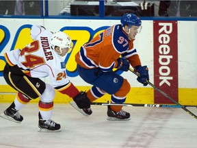 Connor McDavid (97) makes a move to pass Jiri Hudler (24) as the Edmonton Oilers play the Calgary Flames at Rexall Place in Edmonton, Oct. 31, 2015.