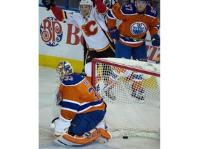 Michael Frolik (67) celebrates the winning goal on goalie Cam Talbot (33) as the Edmonton Oilers lose to the Calgary Flames 5-4 at Rexall Place in Edmonton, Oct. 31, 2015.
