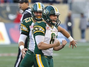 Edmonton Eskimos kicker Sean Whyte (top) celebrates a 53-yard field goal on the final play of the game to beat the Winnipeg Blue Bombers during CFL action at Investors Group Field in Winnipeg on Sat., Oct. 3, 2015.