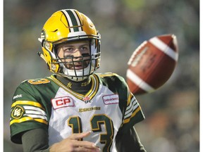 Edmonton Eskimos quarterback Mike Reilly flips the ball to an official after running the ball for an extra point against the Saskatchewan Roughriders in CFL action Saturday that saw the Eskimos win 35-24.