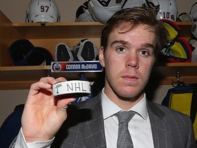 DALLAS, TX - OCTOBER 13:  Connor McDavid #97 of the Edmonton Oilers poses for a photo with his first career NHL goal puck at American Airlines Center on October 13, 2015 in Dallas, Texas.