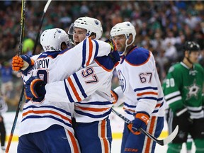 Connor McDavid #97 of the Edmonton Oilers celebrates his first career NHL goal with Nail Yakupov #10 against the Dallas Stars in the second period at American Airlines Center on October 13, 2015 in Dallas, Texas.