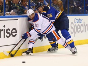 Nail Yakupov (10) of the Edmonton Oilers and Colton Parayko (55) of the St. Louis Blues fight for control of a loose puck at the Scottrade Center on Oct. 8, 2015 in St. Louis, Missouri.