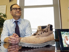 Joe Ceci, Alberta Minister of Finance and President of Treasury Board, prepares Monday for Tuesday's first NDP budget 2015 by displaying his late father's work boots.