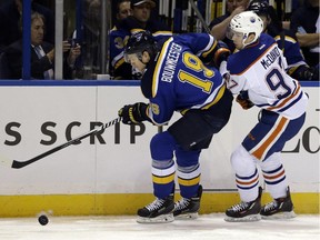 St. Louis Blues' Jay Bouwmeester, left, and Edmonton Oilers' Connor McDavid chase after a puck during NHL action Thursday, Oct. 8, 2015, in St. Louis. The Blues won 3-1.