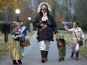 Prime Minister-designate Justin Trudeau, dressed as Han Solo from The Empire Strikes Back, walks with his children Hadrien (second from right), Ella-Grace and Xavier, as his wife Sophie Trudeau-Gregoire, dressed as Princess Leia, jokes with onlookers as the family prepares to go trick-or-treating on Halloween in Ottawa on Saturday, Oct. 31, 2015.