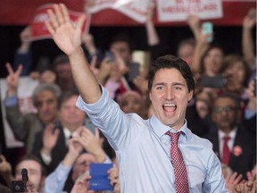 Prime minister-designate Justin Trudeau waves to supporters as he steps onto the stage during a welcome rally in Ottawa, on Oct. 20, 2015.