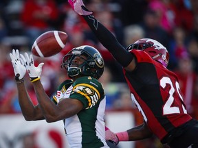 Edmonton Eskimos' Kenny Stafford, left, makes a touchdown catch as Calgary Stampeders' Jamar Wall tries to knock the ball away during first half CFL football action in Calgary, Saturday, Oct. 10, 2015.