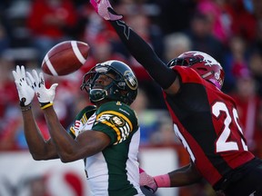 Edmonton Eskimos' Kenny Stafford makes a touchdown catch as Calgary Stampeders' Jamar Wall tries to knock the ball away during CFL football action in Calgary, Saturday, Oct. 10, 2015.