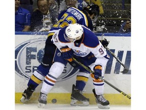 Edmonton Oilers' Connor McDavid, front, collides with St. Louis Blues' Kevin Shattenkirk along the boards during the first period. Oct. 8, 2015, in St. Louis.