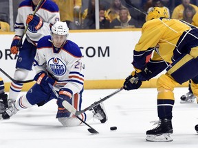 Edmonton Oilers left wing Lauri Korpikoski (28) battles for the puck with Nashville Predators centre Calle Jarnkrok, right,  in the first period of an NHL  game Saturday, Oct. 10, 2015, in Nashville, Tenn.