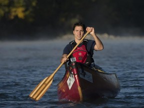 Prime minister-designate Justin Trudeau paddles a canoe down the Bow River in Calgary on Sept. 17.
