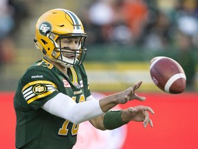 Edmonton Eskimos quarterback Mike Reilly flips a short pass during a CFL game at Commonwealth Stadium on Oct. 17, 2015.