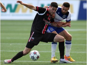 Ottawa Fury FC midfielder Drew Beckie gets tied up by FC Edmonton midfielder Ritchie Jones as the two sides met at TD Place on Sunday, Oct. 4, 2015. Ottawa won 2-0.